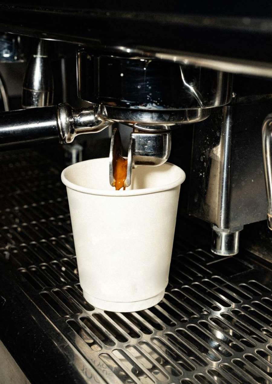Espresso pouring into a white cup